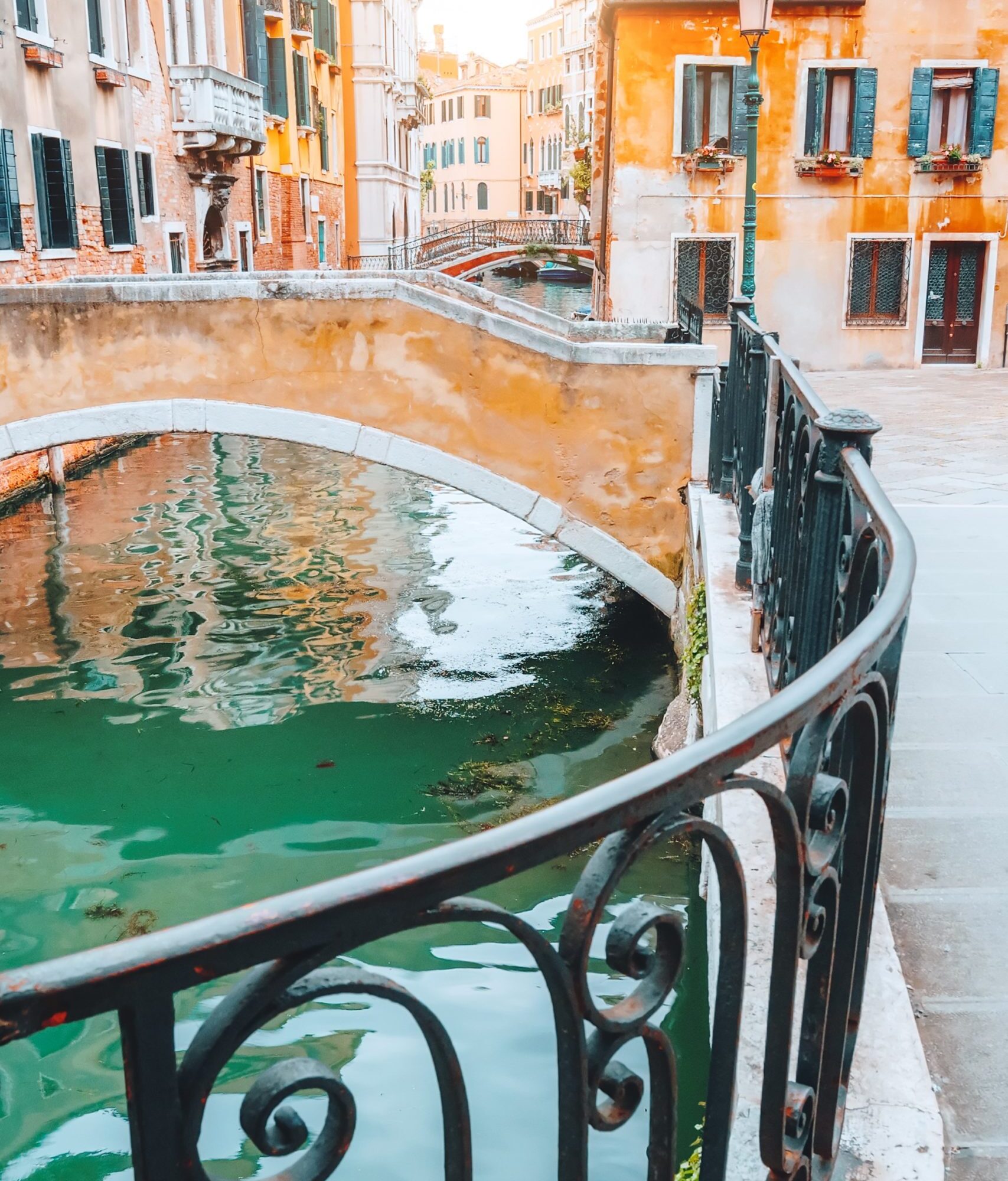 scenic-canal-with-bridge-and-colorful-buildings-in-FVSFK7H