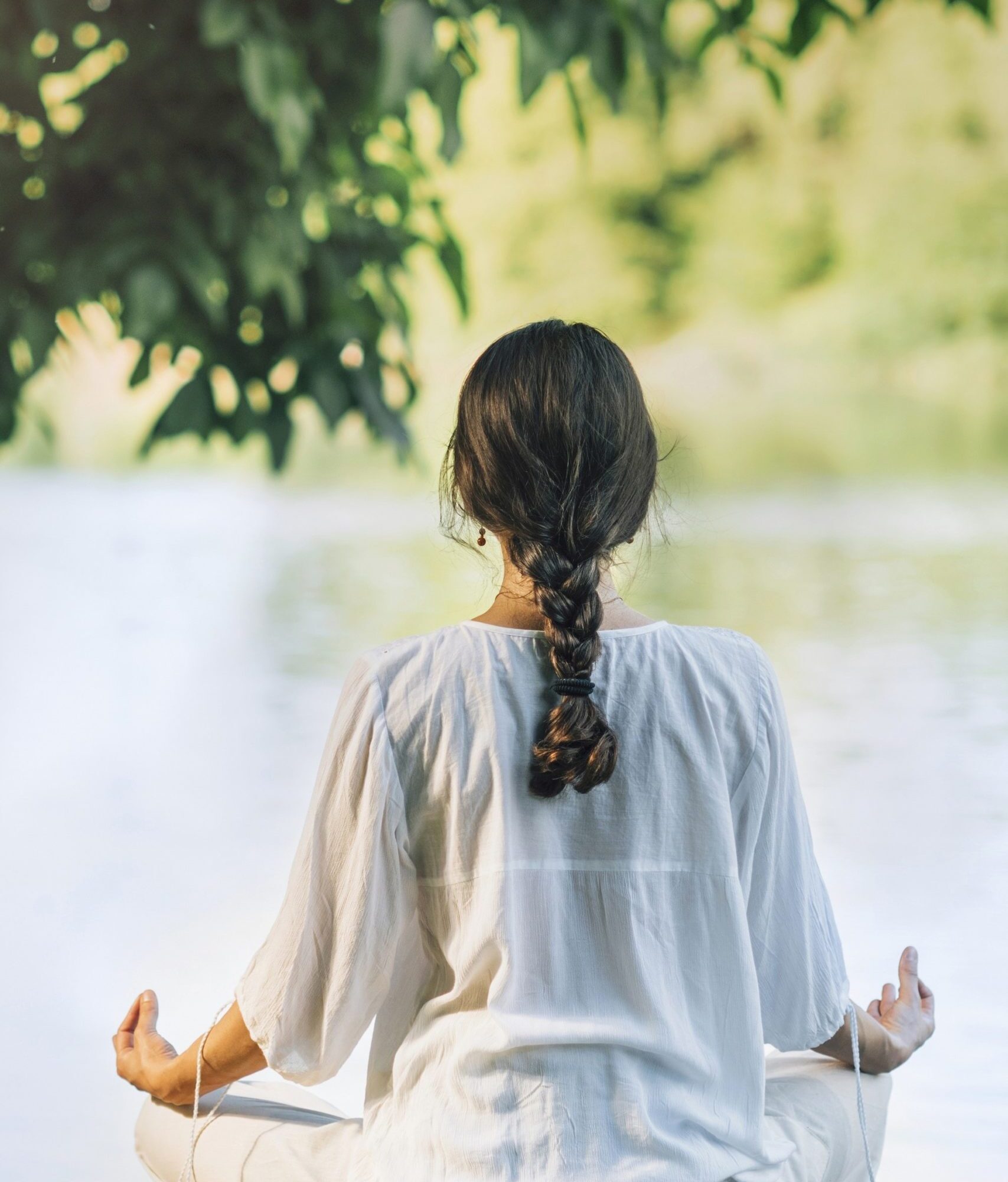 yoga-retreat-peaceful-young-woman-sitting-in-lotus-7B5N93A